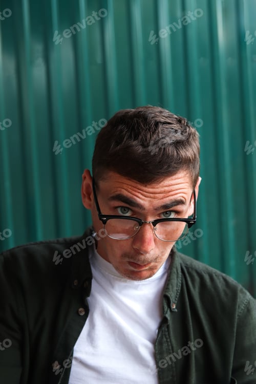 Preview: Funny young man. Man wearing eyeglasses. Happy smiling smart man. Portrait of handsome smiling styli
