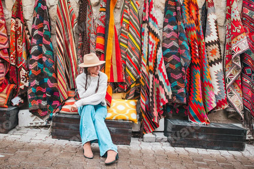 Preview: Old traditional Turkish carpet shop in cave house Cappadocia, Turkey Kapadokya. Young woman on