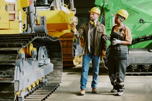 Preview: Two Colleagues Having Conversation At Work In Industrial Plant