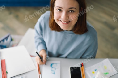Preview: Young Woman Draws While Smiling Upward