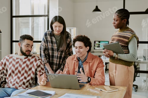 Preview: Biracial Programmers Having Brainstorm in Office