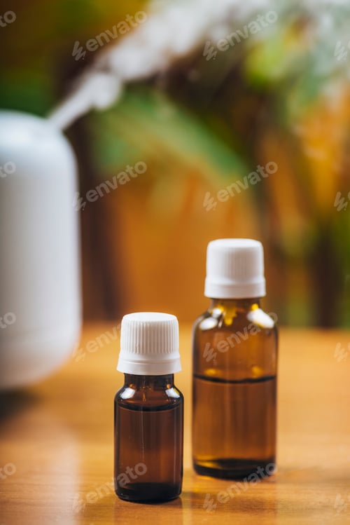 Preview: Natural Essential Oil Bottles and Aroma Therapy Diffuser on a Wooden Table