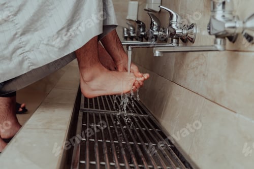 Preview: A Muslim performing ablution. Ritual religious cleansing of Muslims before performing prayer. The