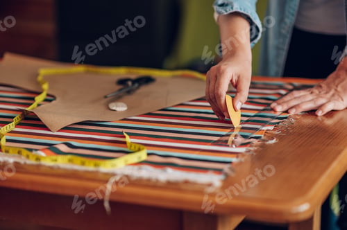 Preview: Woman tailor hands working from home and tailoring beautiful clothes