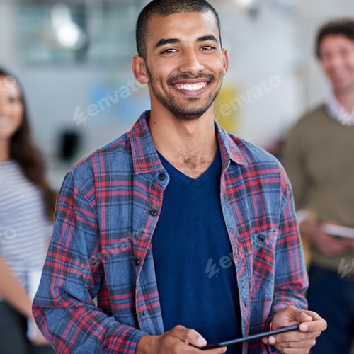 Preview: I know I belong here. Cropped portrait of a young man with colleagues in the background.