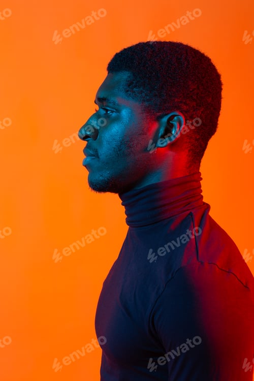 Preview: African american young man side portrait, neon light