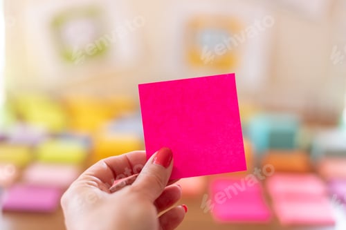 Preview: Woman’s hand holding blank pink note