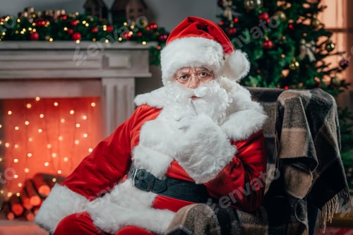 Preview: angry santa claus in traditional red costume gesturing and sitting in armchair