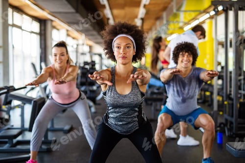 Preview: Group of young people, friends smiling and enjoy sport in gym. People exercise, work out concept.