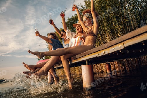 Preview: Group of female friends enjoying a summer day at the lake.