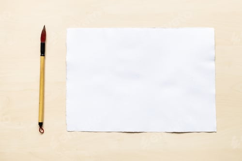 Preview: calligraphy brush near blank sheet of white paper