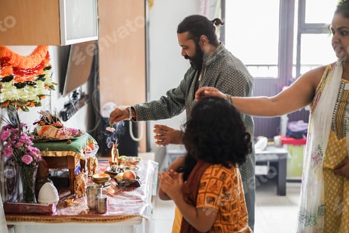 Preview: Indian family celebrating Diwali or hindu festival at home - Focus on father face