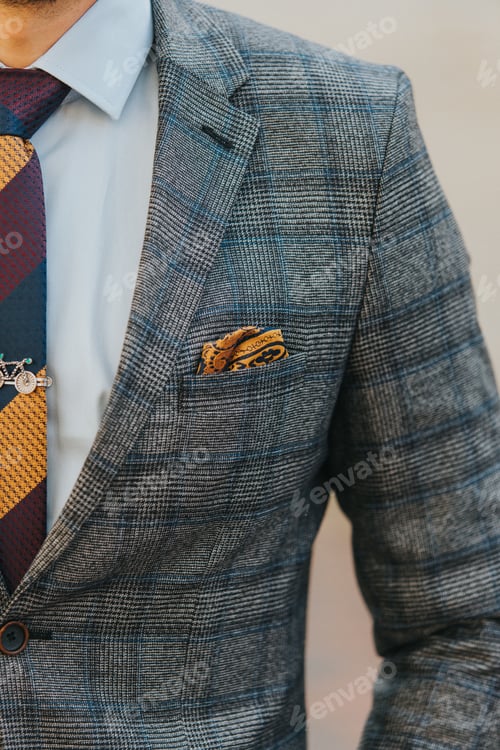 Preview: Vertical close-up shot of a man wearing a gray plaid suit