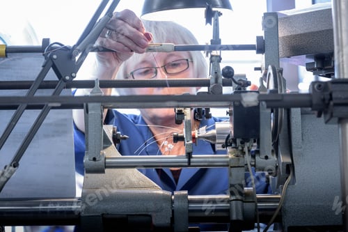 Preview: Female worker winding electromagnetic coils in electronics factory