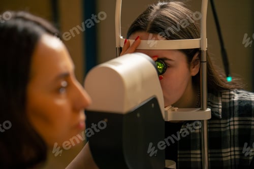 Preview: close-up in an ophthalmology clinic The girls inserted the lens and looked at the bottom of the eye
