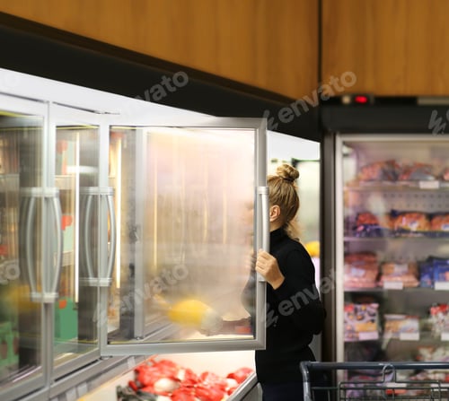 Preview: Woman Choosing Frozen Food From A Supermarket Freezer