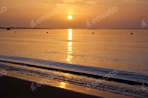 Preview: Big yellow sun setting down over sea surface