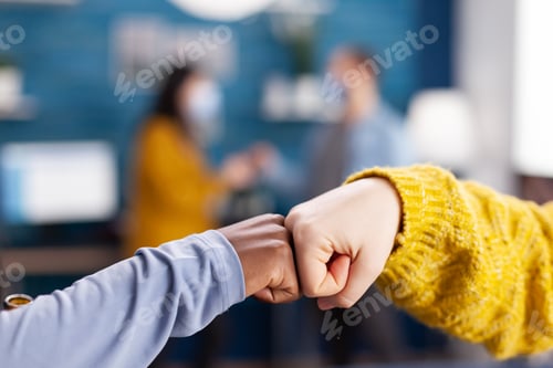 Preview: Close up of african woman and friend doing fist bump