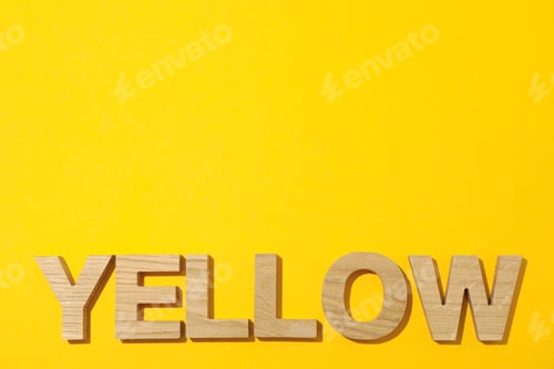 Preview: Word Yellow laid out in wooden letters on color background