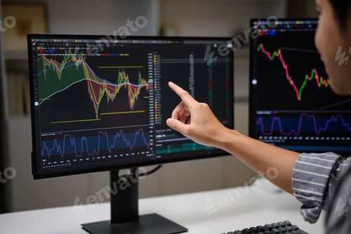 Preview: Close-up of trader pointing at stock chart on computer screen during market analysis