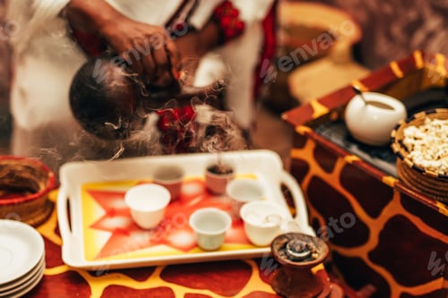 Preview: Traditional african barista preparing coffee as in its origin as a steaming hot beverage.