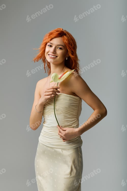 Preview: Young woman with red hair radiates spring elegance in a sensual strapless dress