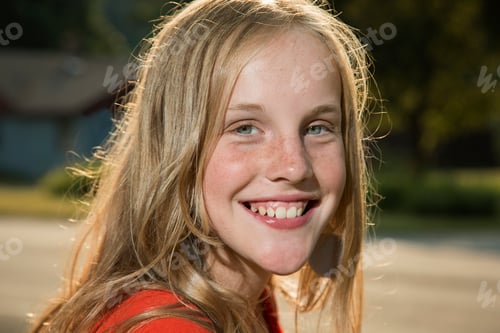 Preview: Close up portrait of blonde girl looking at camera smiling