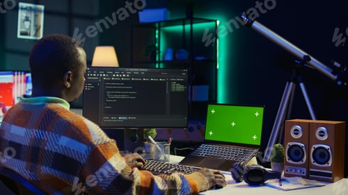 Preview: Black web developer handling database servers for safety with green screen