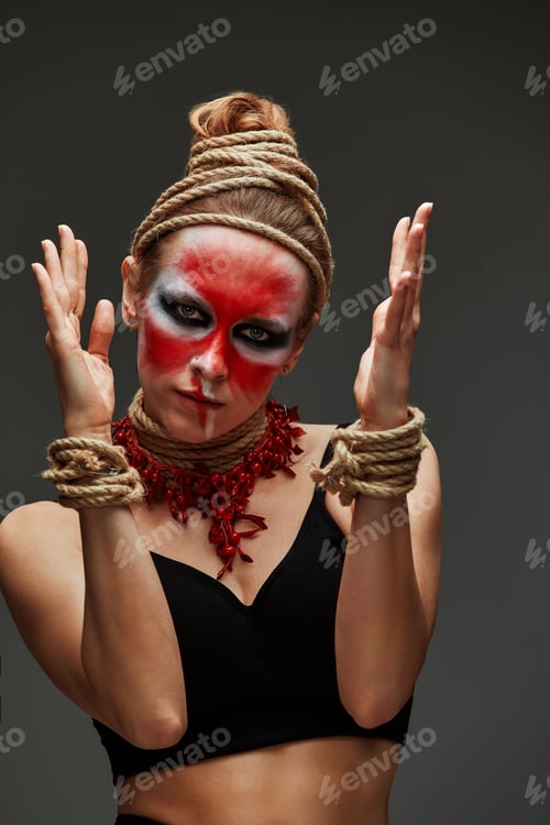Preview: close up portrait of young beautiful girl with colorful face painting. Halloween professional makeup