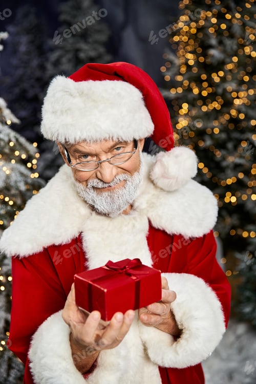 Preview: Santa Claus joyfully presents a gift amidst festive decorations and twinkling lights