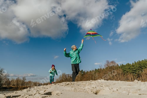 Preview: Father with his 5 years old daughter prepairing kite to fly