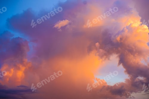 Preview: Big bright colorful thunder cloud at grave sunset.