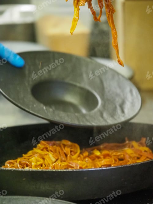 Preview: chef plating tagliatelle sauce pasta into black design dishes - mise en place