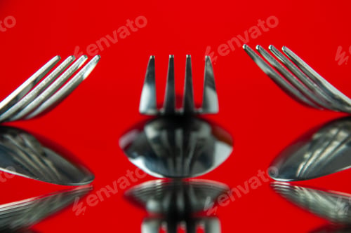 Preview: front close view metal forks on red background cutlery kitchen food color photo table dinner