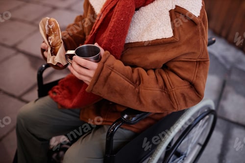 Preview: Man with disability eating street food snacks outdoors