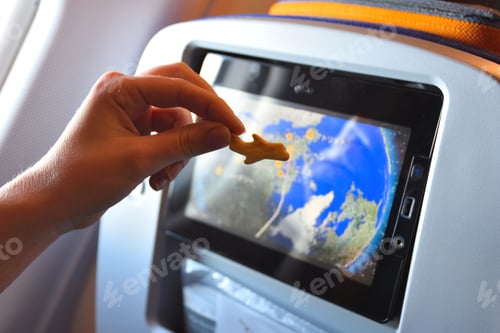 Preview: Human hand holding a cookie in the airplane during a flight travel