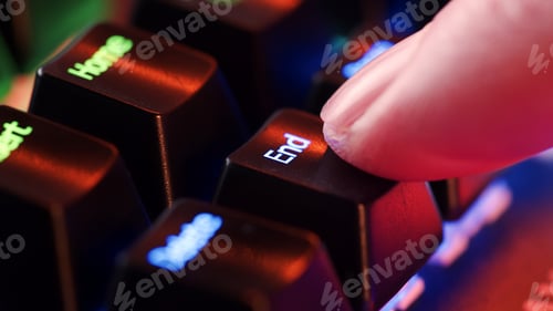 Preview: Human finger clicks on the End key on the computer keyboard, close up view.