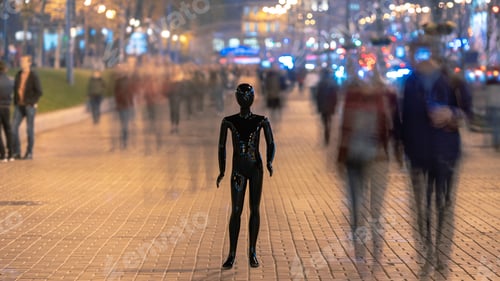 Preview: The black mannequin stands on the street among the stream of people