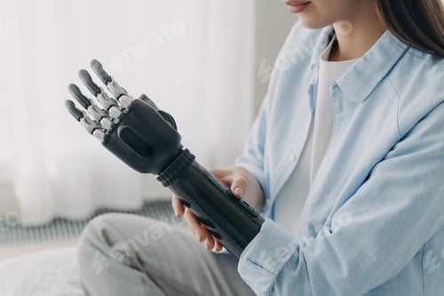 Preview: Application of bionic hands. Disabled woman customizing sensory robotic prosthetic arm, close up