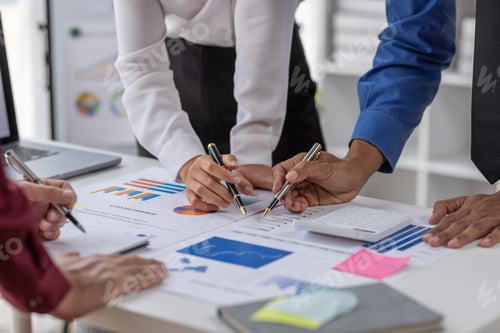 Preview: Group of confident business people point to graphs and charts to analyze market data, balance sheet,