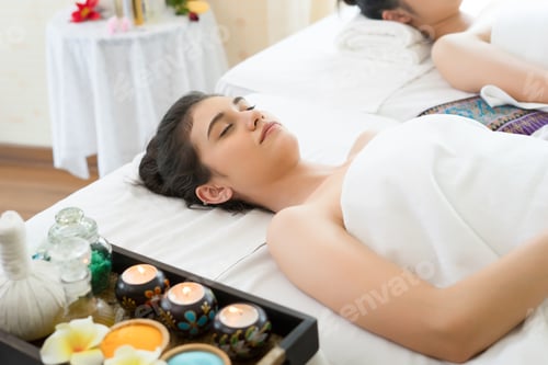 Preview: Asian beautiful woman lying relax on white bed in spa