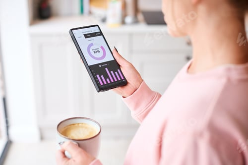 Preview: Close Up Of Woman Looking At Sleep Tracking App On Mobile Phone At Home