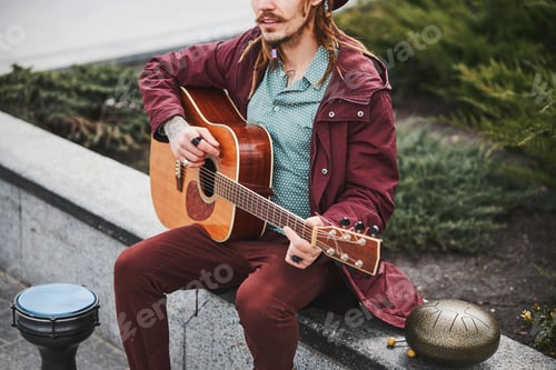 Preview: Close up of young man playing the guitar