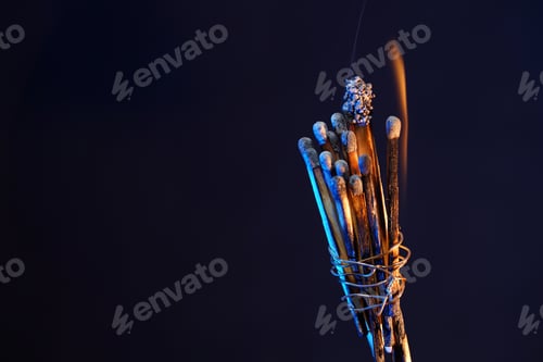 Preview: Macro of burned matchsticks on a dark background