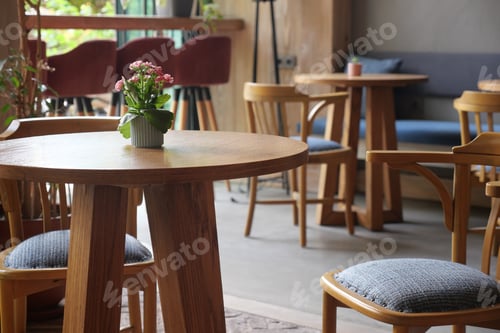 Preview: Cozy cafe interior with wooden furniture and greenery