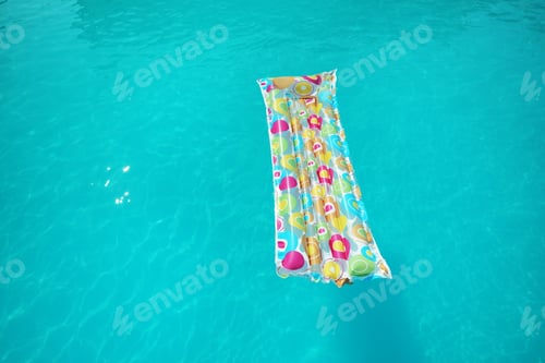 Preview: Colorful inflatable mattress floating in swimming pool on sunny day. Space for text