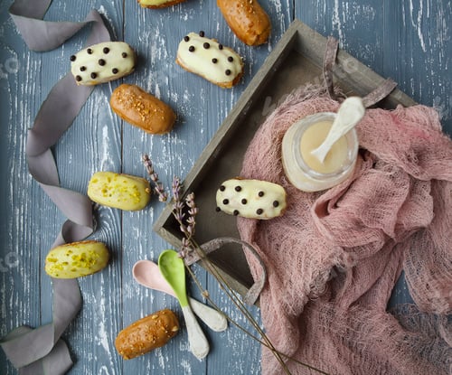 Preview: Eclairs with chocolate and whipped cream on dark background