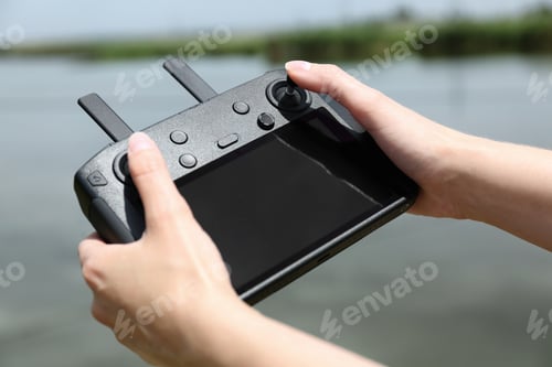 Preview: Woman with modern drone controller outdoors, closeup