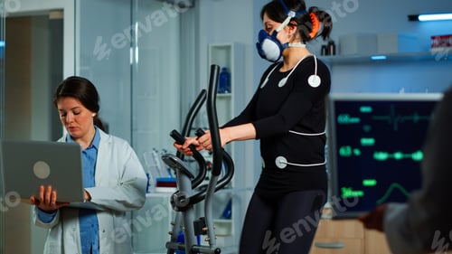 Preview: Medical researcher using laptop while measuring sportsman endurance