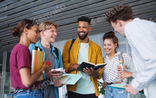 Preview: Group of university students standing in corridor indoors, talking and laughing
